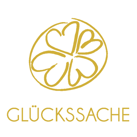 Das goldene Glückssache Logo besteht aus 4 Kleeblättern in einem Kreis